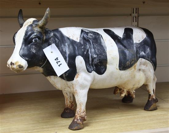 A painted cast iron model of a dairy cow